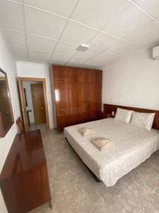 a bedroom with a bed and a table in it at Cozy Apartment in Centre of Alicante near Plaza de Toros in Alicante