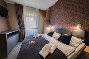 Posteľ alebo postele v izbe v ubytovaní Srebrny Bucznik Wellness & Restaurant