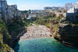 a group of people on a beach in the water at Villa Francesca Appartamento Meraviglioso in Polignano a Mare