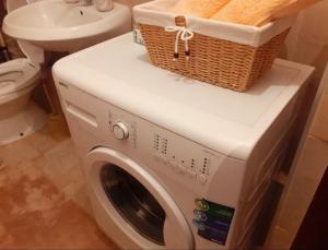 a washing machine with a basket on top of it in a bathroom at Apartman Sarajevo in Sarajevo