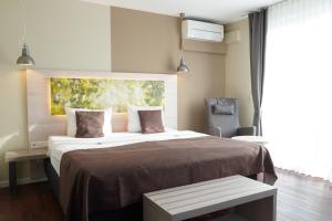 莫尔巴赫Best Western Hotel St. Michael的带一张大床和一把椅子的卧室