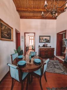 a dining room with a wooden table and chairs at Villa Antigoni Serifos in Serifos Chora +19 photos