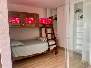 a bedroom with two bunk beds and a closet at Céntrico mini departamento, moderno y acogedor in Lima