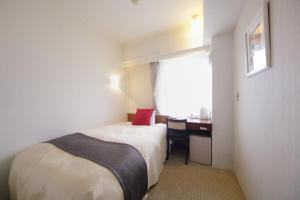 Postel nebo postele na pokoji v ubytování Grand Park Hotel EX Fukushimaebisu