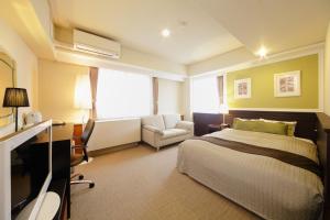 Postel nebo postele na pokoji v ubytování Grand Park Hotel EX Fukushimaebisu