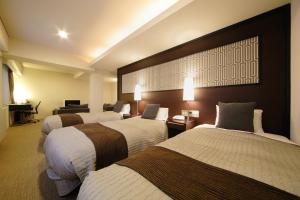 Postel nebo postele na pokoji v ubytování Grand Park Hotel EX Fukushimaebisu