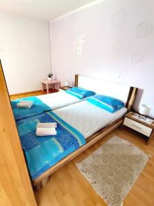 a bedroom with a bed with two towels on it at Apartments Špik in Cerkno