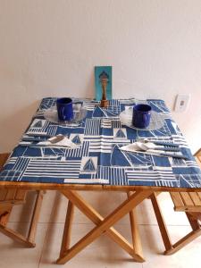 a table with a blue and white table cloth on it at A Taberna - chalés in Alto Paraíso de Goiás