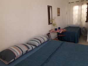 a bedroom with two pillows on a bed with a table at A Taberna - chalés in Alto Paraíso de Goiás