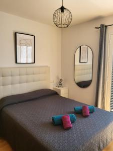 a bedroom with a bed with two pillows on it at Casa Playa La Fontanilla SOTOLODGE in Conil de la Frontera