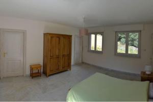 a bedroom with a bed and a wooden cabinet at Gite GRETEL de la Ferme du Schneeberg in Wangenbourg