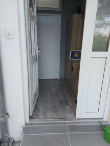 an open door leading to a hallway with a kitchen at Eid in Mostar