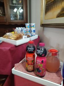 a refrigerator with two bottles of salsa and drinks at Hotel Mirage in Messina