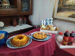 a table with two plates of food and waffles on it at Hotel Mirage in Messina