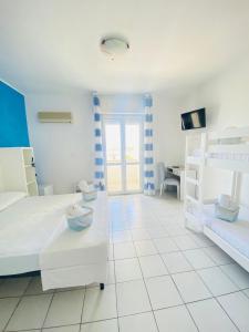 Postel nebo postele na pokoji v ubytování Albergo California