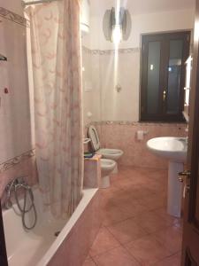 a bathroom with a toilet and a sink and a shower at CASA VACANZE AMBRA in Gioiosa Marea