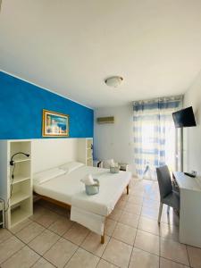 Postel nebo postele na pokoji v ubytování Albergo California