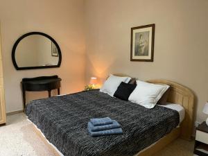 a bedroom with a bed with two towels on it at Olivier House Mellieha in Mellieħa