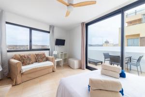 a bedroom with a bed and a living room at Flatguest CotilloMar in Cotillo