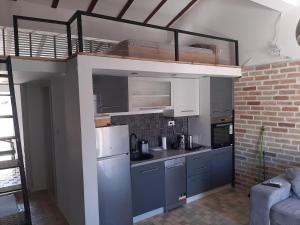 a kitchen with blue cabinets and a white refrigerator at Budva stan Natasa in Budva