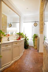 a bathroom with a mirror and a sink in a room at La Maison d'Etrusque in Tarquinia