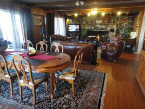 a living room with a wooden table and chairs at Airport Inn Motel in Quesnel