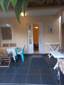 a patio with a table and chairs and a door at Bungalo Đeković in Ulcinj