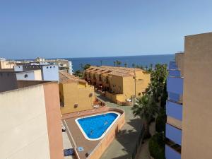 a view of a swimming pool from a building at Luxurious 2 bedroom apartment near Cabo Roig strip in Playas de Orihuela