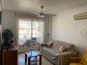 a living room with a couch with a baby on it at Luxurious 2 bedroom apartment near Cabo Roig strip in Playas de Orihuela