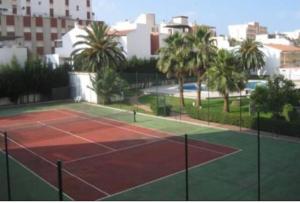a tennis court with palm trees in a city at Estudio cerca de la playa 3 in Málaga