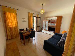 a living room with a couch and a table at Villa Barraco Paradise in San Vito lo Capo
