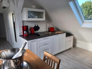 a kitchen with white cabinets and a counter top at Bredeney View in Essen