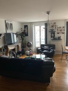 a living room with a couch and a table at Appartement Au Quai 1921 in Besançon