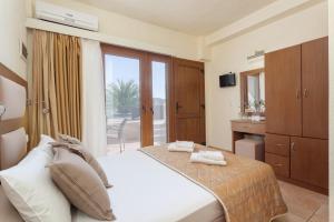 a bedroom with a bed and a bathroom with a window at Blue Green Bay in Panormos Skopelos