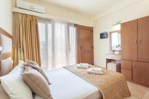 a hotel room with a bed and a window at Blue Green Bay in Panormos Skopelos
