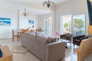 uma sala de estar com um sofá e uma mesa em Blue Horizon View em Lávrion