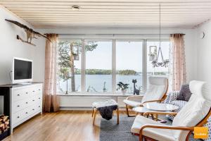 a living room with a view of the water at Ekudden. Idylliskt nära sjö. Egen strand. in Rimforsa
