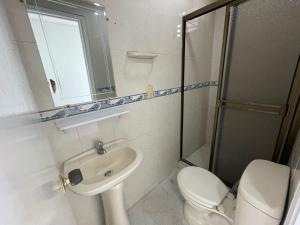 a bathroom with a toilet, sink, and shower at Apartamentos En Edificio Portofino in Cartagena de Indias