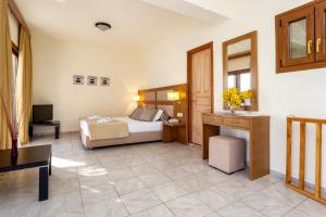 a hotel room with a bed and a desk at Blue Green Bay in Panormos Skopelos