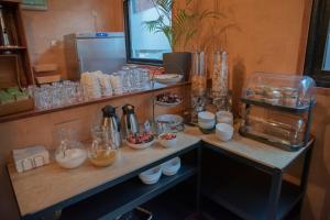 a counter with glasses and bowls of food on it at Simplon Hostel in Groningen