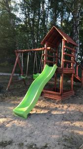 a playground with a slide and a swing at Holenderka Artur in Stegers