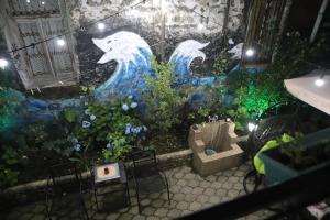 a room with a painting of dolphins on a wall at Hotel Black Sea House in Batumi