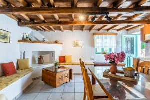 a living room with a table and a couch at La Belle Merle in Panormos Skopelos +22 photos