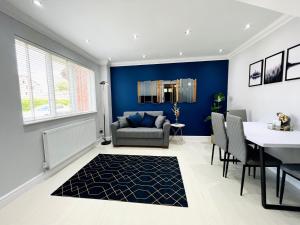 a living room with a blue accent wall at Modern Home, Close to the City Centre with Parking in Birmingham