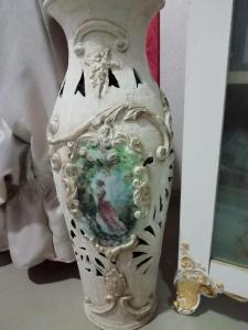 a white vase with a picture of a bird on it at Guest House Orchidea in Pomorie