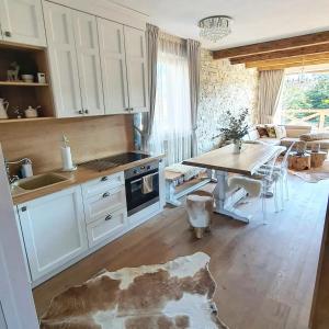 a kitchen with a table and a dining room at Chalet Rebeca 12 beds Donovaly in Donovaly