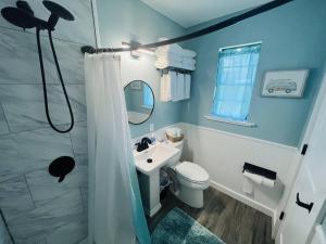 a bathroom with a toilet and a sink and a shower at 1915 Beach Club in Daytona Beach