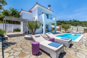 a villa with a swimming pool and a house at Villa Mariel Skopelos in Skopelos Town