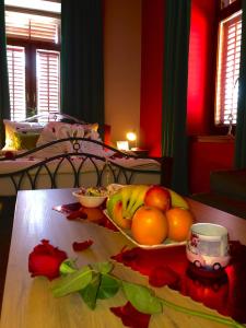 a bowl of fruit on a table in a bedroom at Vienna Story Guesthouse in Mostar