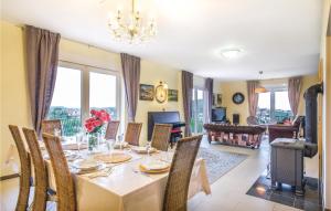 a dining room with a table with chairs and a chandelier at Cozy Home In Zagreb With Sauna in Zagreb